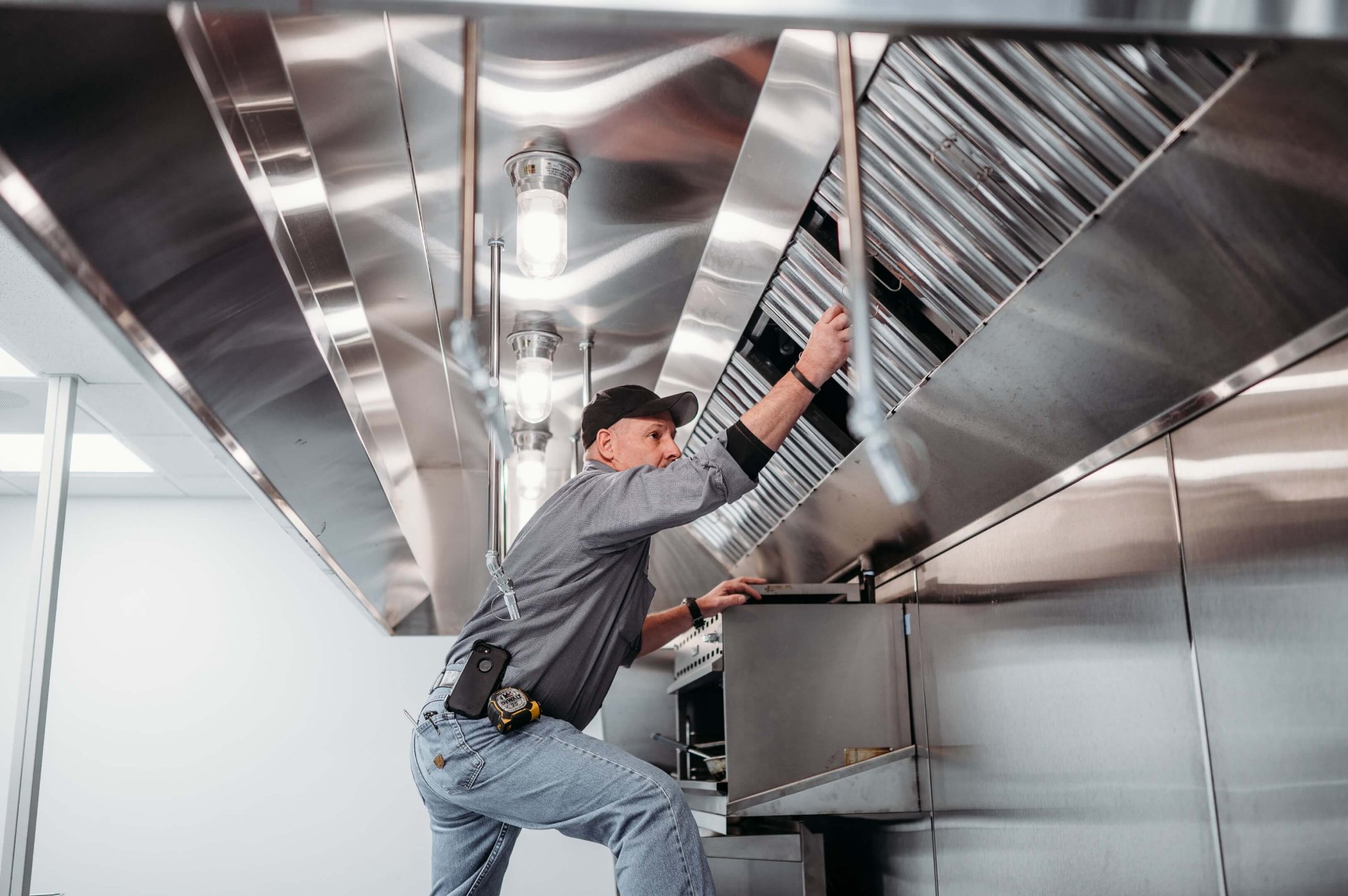 Cache Valley Fire Protection technician inspecting commercial kitchen suppression system